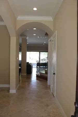 a view of a hallway with a livingroom and a couch