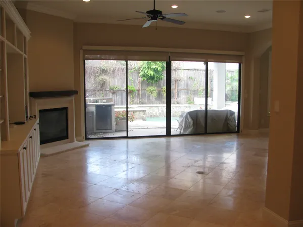 a view of an empty room with a fireplace and a large window