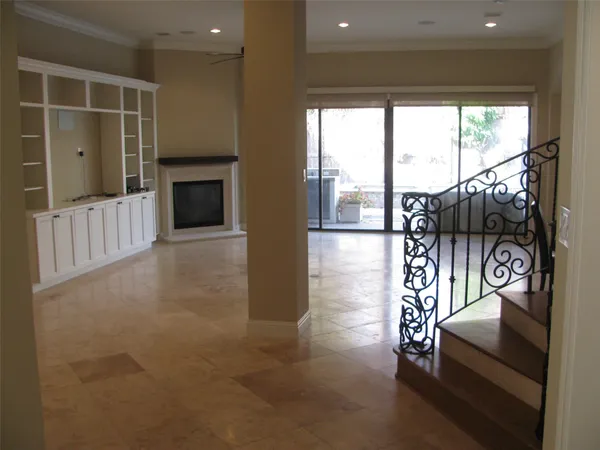 a hallway with a couch and a fireplace
