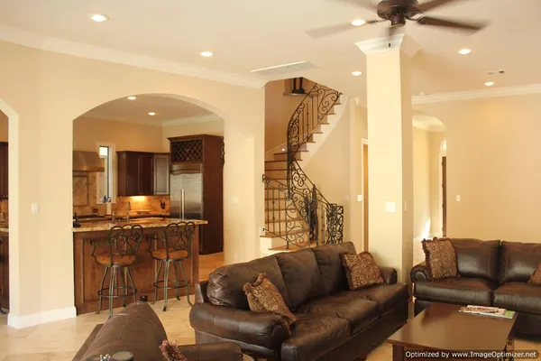 a living room with furniture and a chandelier