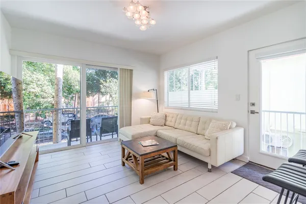 a living room with furniture and a floor to ceiling window