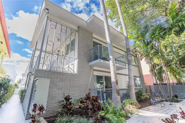 a view of a patio with table and chairs and potted plants