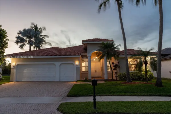 a front view of house with yard and green space