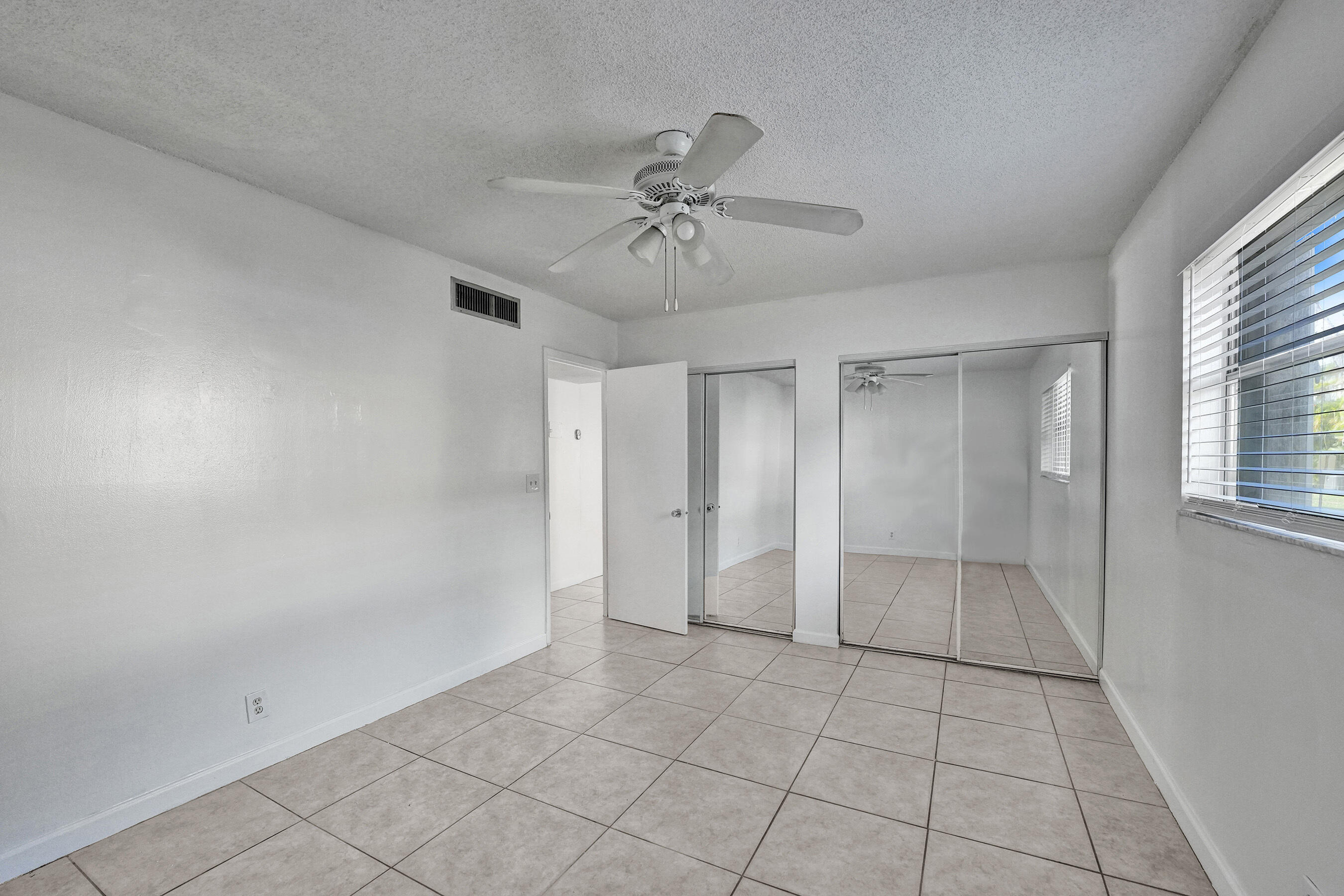 600 Southeast 2nd Avenue, Unit K2 Deerfield Beach, FL 33441 - Photo 20 of 29 wooden floor in an empty room with a window