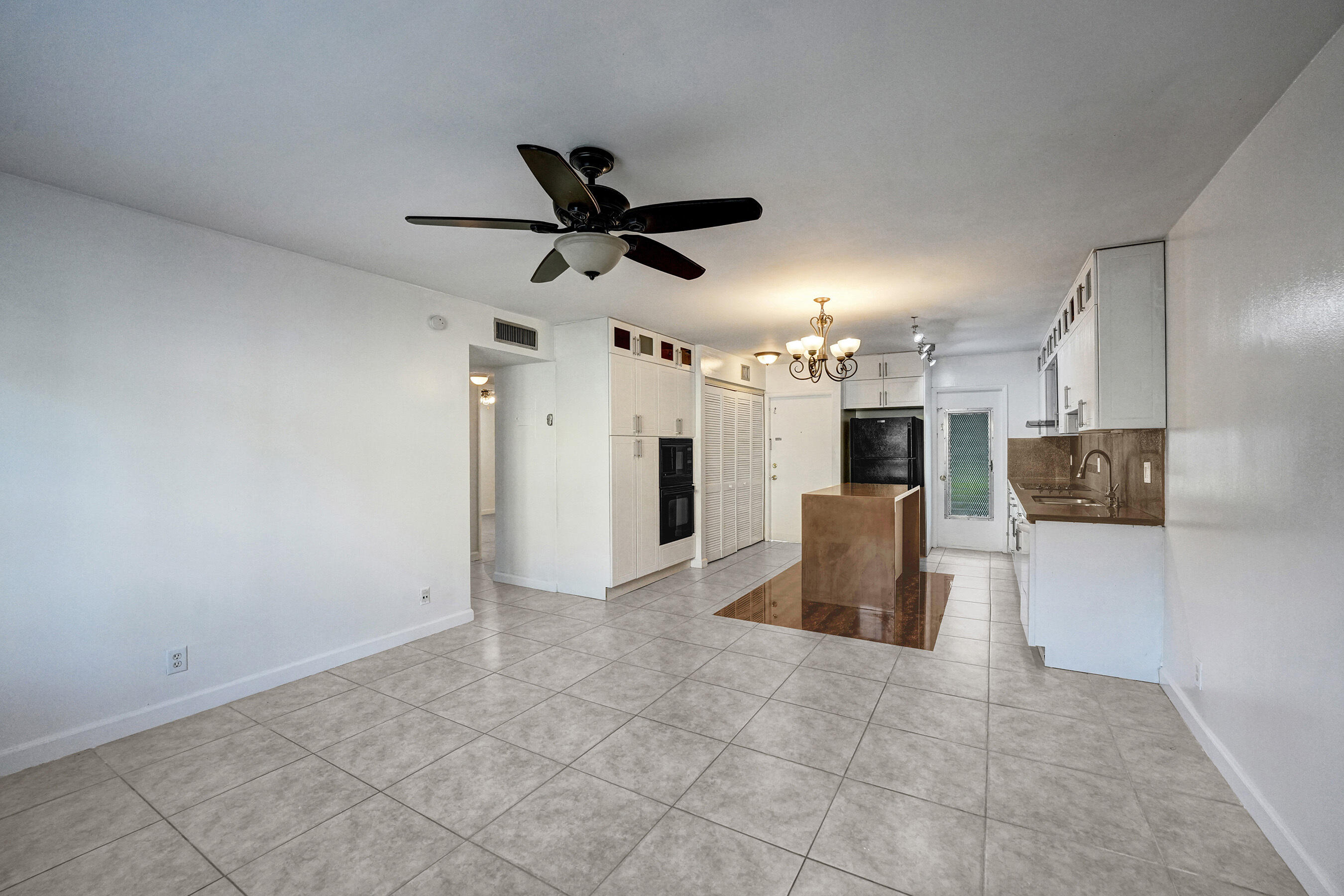 600 Southeast 2nd Avenue, Unit K2 Deerfield Beach, FL 33441 - Photo 9 of 29 a view of a kitchen with a sink and a refrigerator
