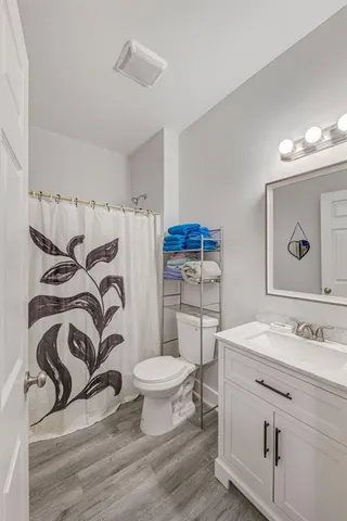 a bathroom with a sink toilet and a mirror
