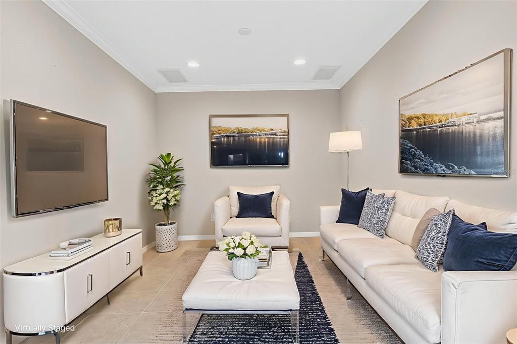 13738 Messina Loop, Unit 103 Bradenton, FL 34211 - Photo 20 of 99 a living room with furniture and a flat screen tv