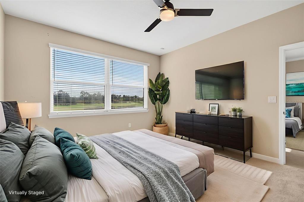 13738 Messina Loop, Unit 103 Bradenton, FL 34211 - Photo 36 of 99 a bedroom with a bed and a flat screen tv