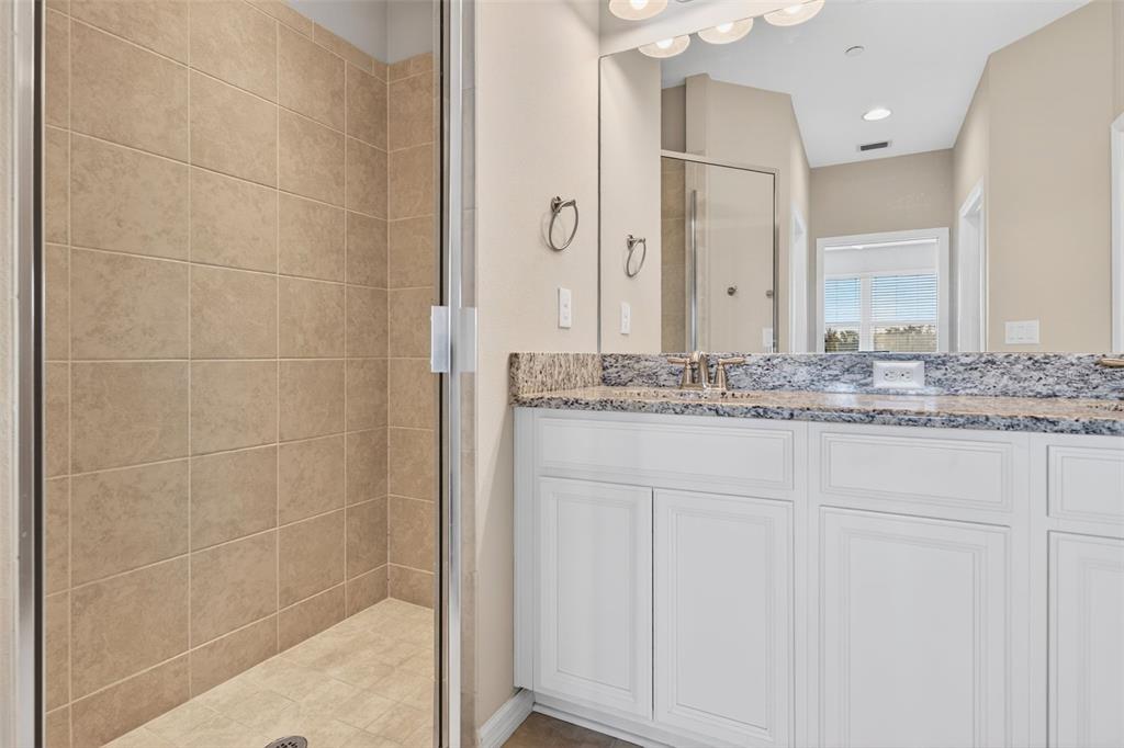 13738 Messina Loop, Unit 103 Bradenton, FL 34211 - Photo 43 of 99 a bathroom with a granite countertop sink and a mirror