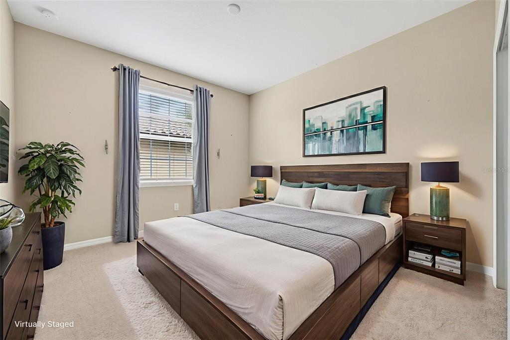 13738 Messina Loop, Unit 103 Bradenton, FL 34211 - Photo 46 of 99 a bedroom with a bed and a potted plant