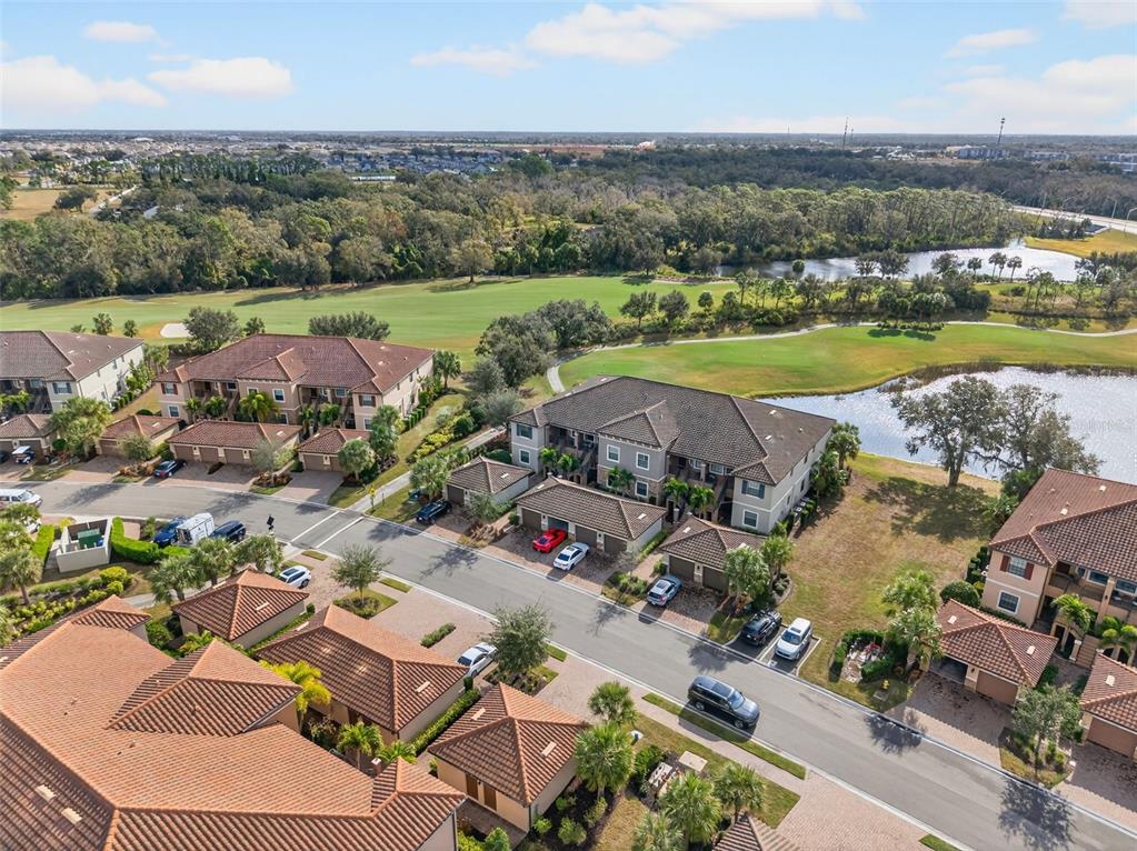 13738 Messina Loop, Unit 103 Bradenton, FL 34211 - Photo 61 of 99 an aerial view of a houses with a lake view