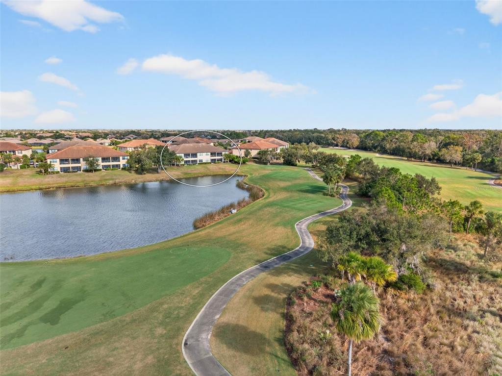13738 Messina Loop, Unit 103 Bradenton, FL 34211 - Photo 71 of 99 a view of a lake with houses in the back