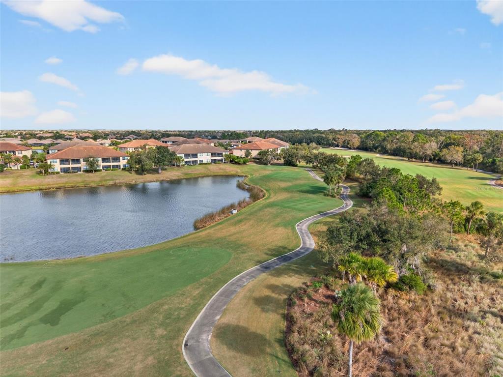 13738 Messina Loop, Unit 103 Bradenton, FL 34211 - Photo 72 of 99 a view of a lake with a city