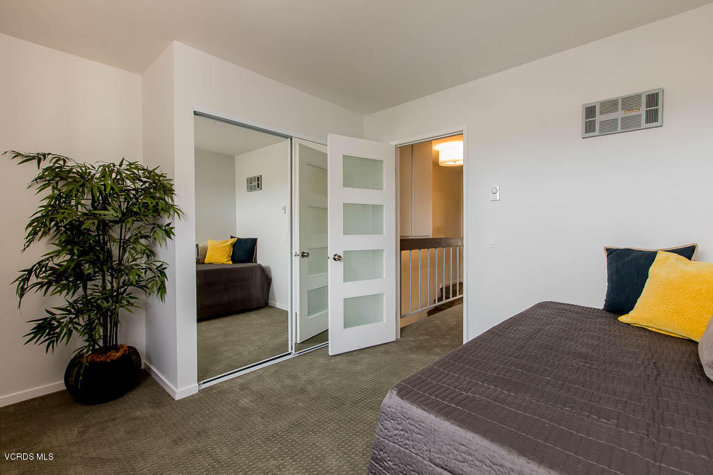 209 South Ventura Road, Unit 31 Port Hueneme, CA 93041 - Photo 18 of 41 a bedroom with a bed and a potted plant
