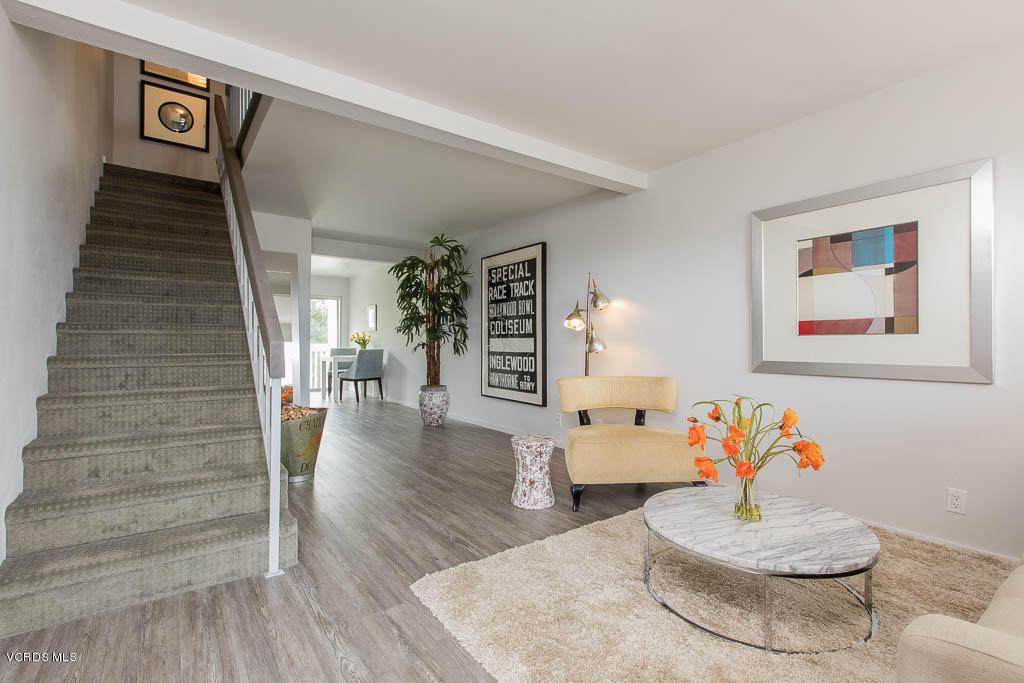 209 South Ventura Road, Unit 31 Port Hueneme, CA 93041 - Photo 4 of 41 a living room with furniture and a wooden floor