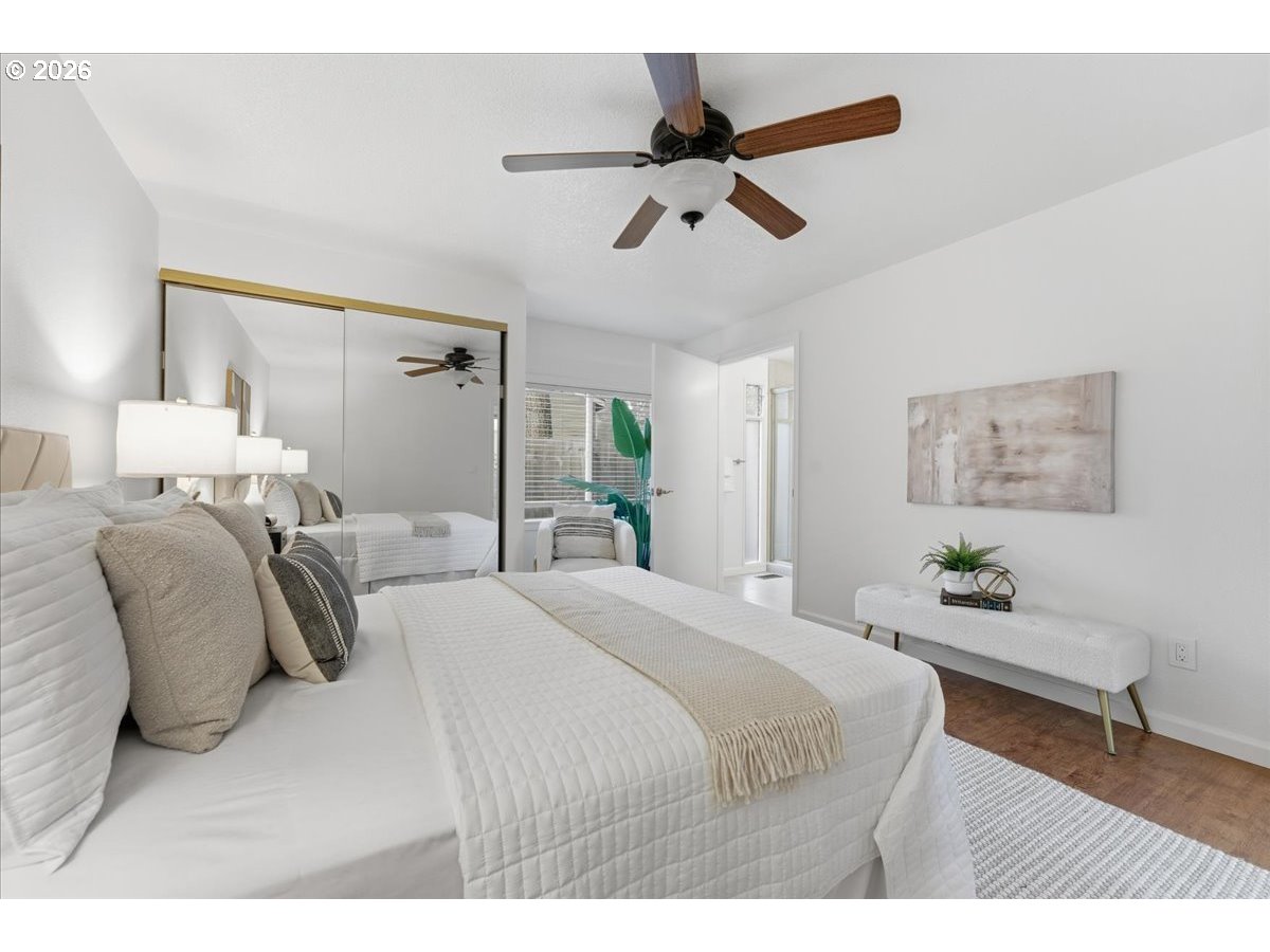 14825 Southwest Village Lane Beaverton, OR 97007 - Photo 18 of 32 a bedroom with a bed and a chandelier