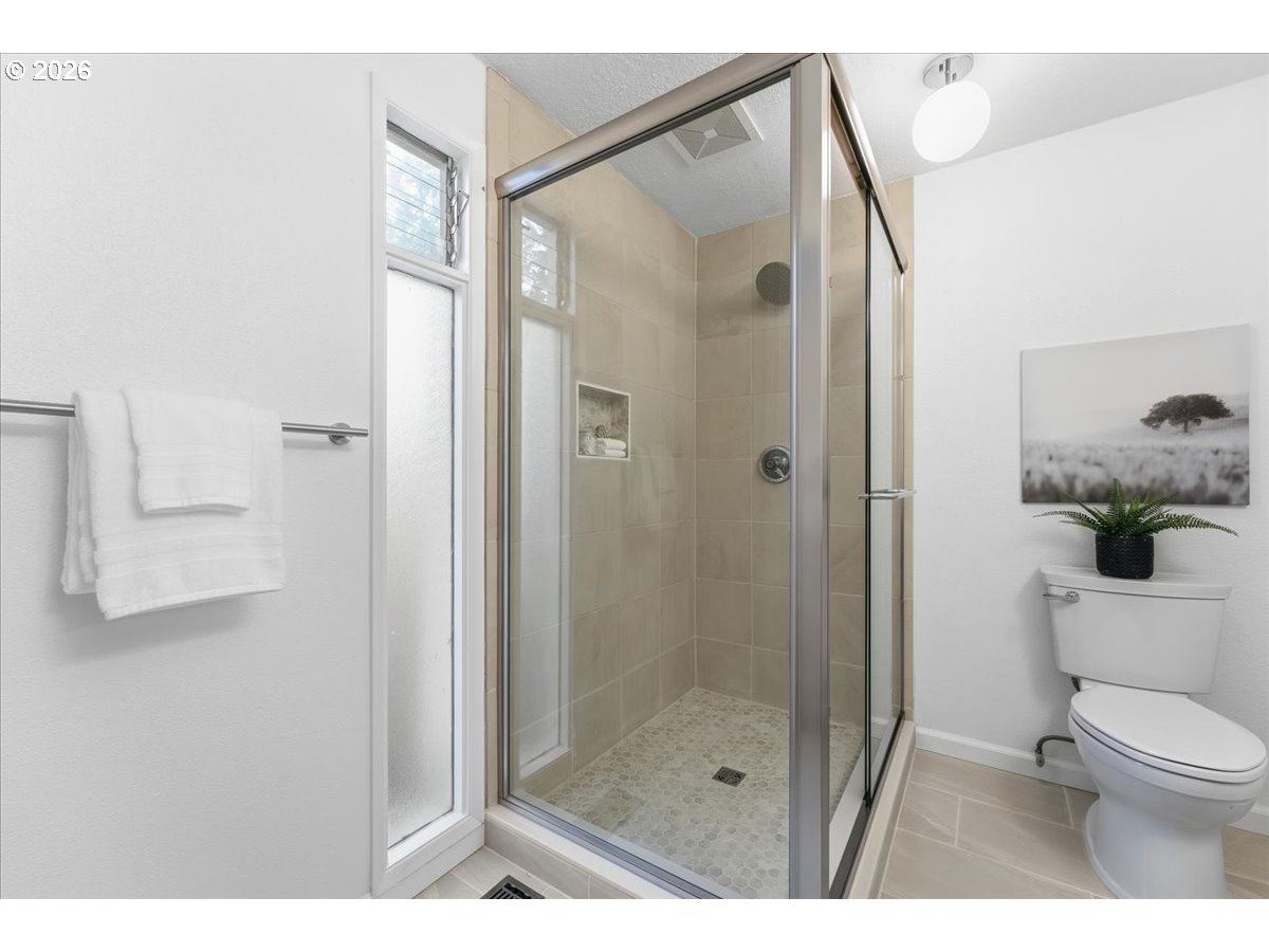 14825 Southwest Village Lane Beaverton, OR 97007 - Photo 21 of 32 a bathroom with a shower and a toilet