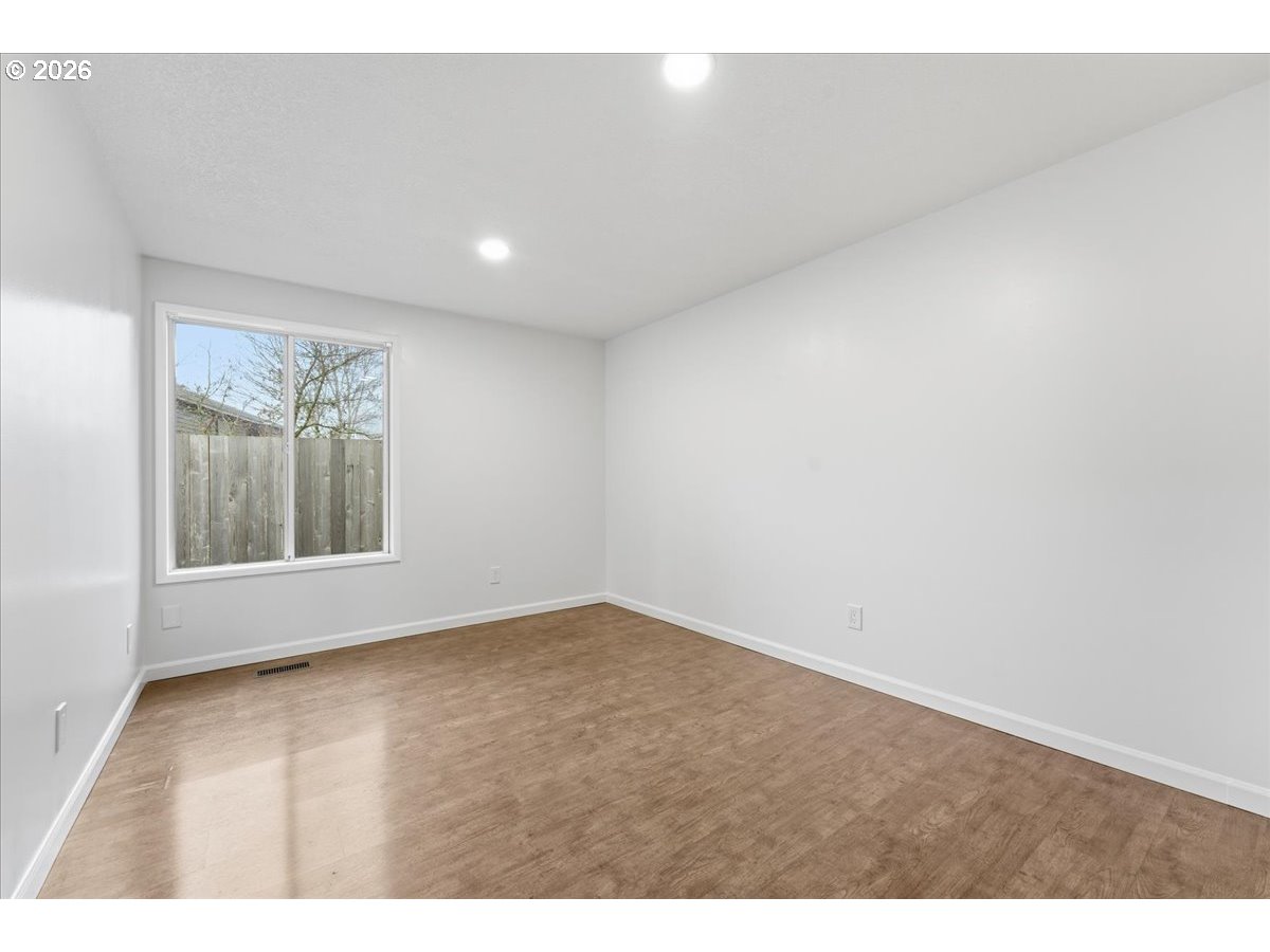 14825 Southwest Village Lane Beaverton, OR 97007 - Photo 22 of 32 a view of an empty room with a window