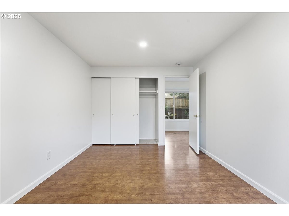 14825 Southwest Village Lane Beaverton, OR 97007 - Photo 23 of 32 a view of an empty room with wooden floor