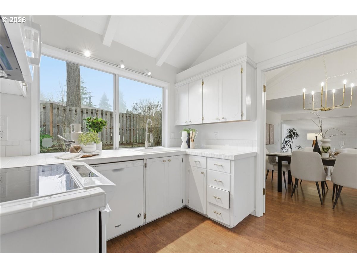 14825 Southwest Village Lane Beaverton, OR 97007 - Photo 10 of 32 a kitchen with a sink cabinets and wooden floor