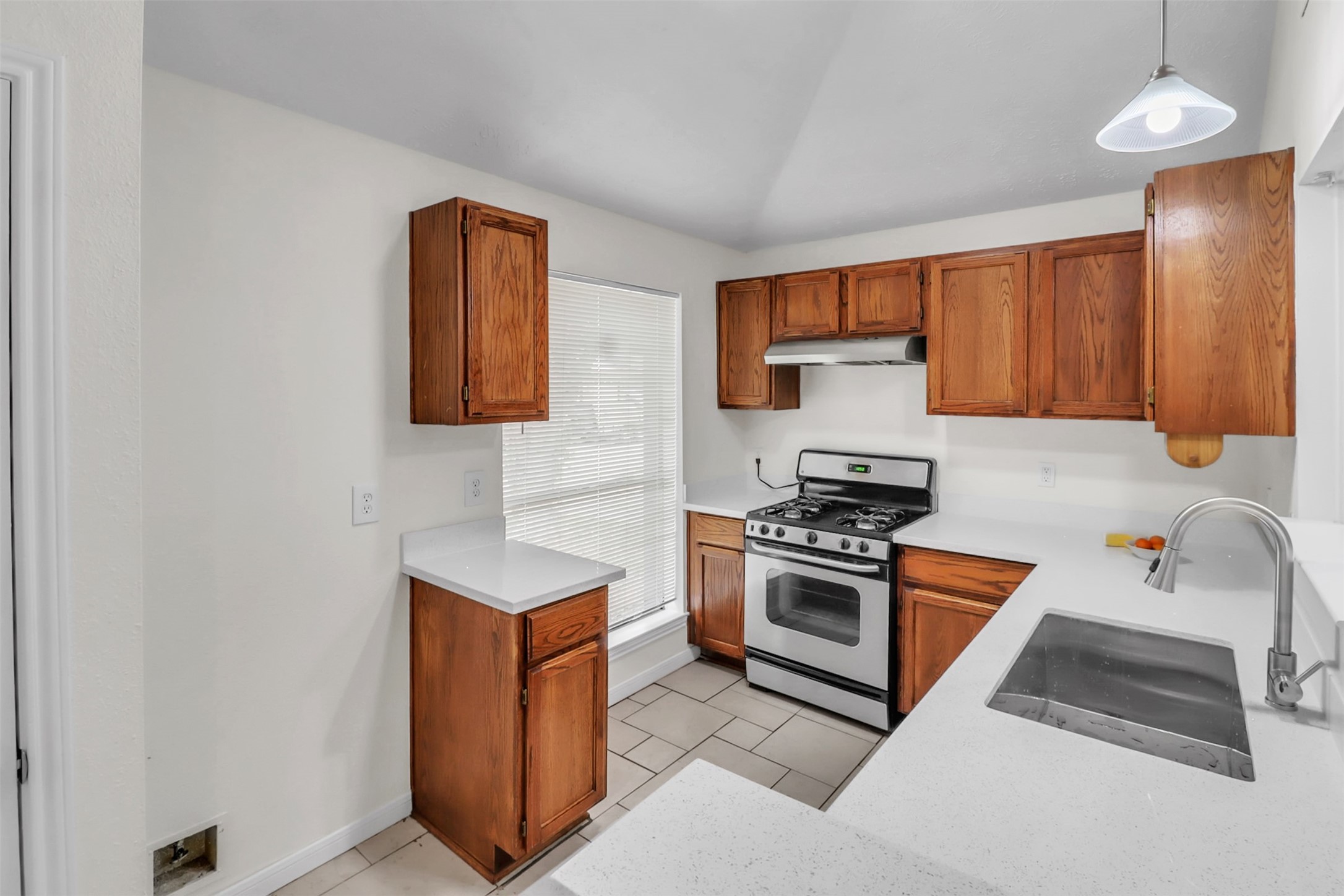 15116 Sheffield Terrace Channelview, TX 77530 - Photo 5 of 16 a kitchen with stainless steel appliances granite countertop a stove a sink and a refrigerator
