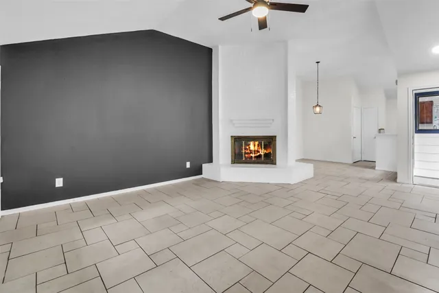 a view of an empty room with a fireplace