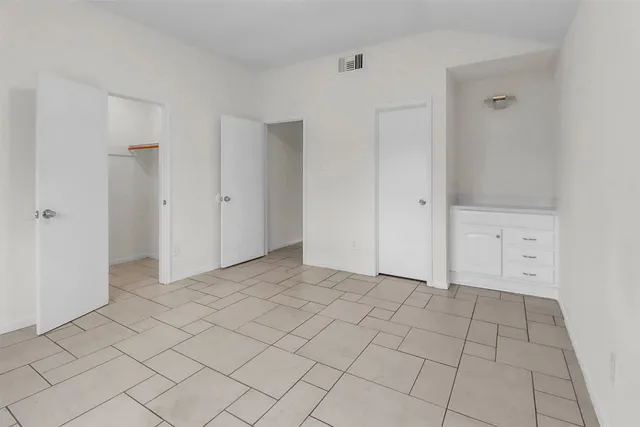 a view of an empty room and closet area