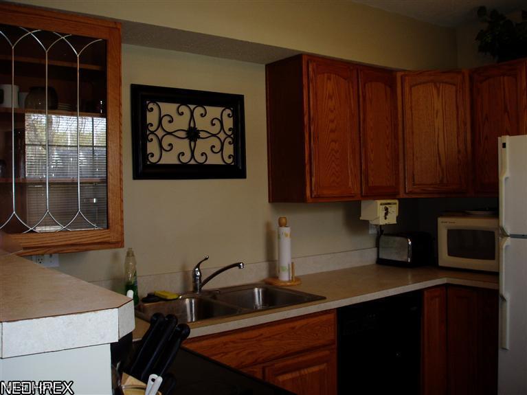 1800 Clyde Road Madison, OH 44057 - Photo 2 of 25 A leaded glass display cabinet is featured in the oak kitchen.
