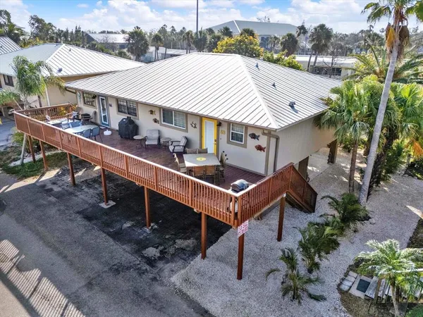 an aerial view of a house with balcony and outdoor space