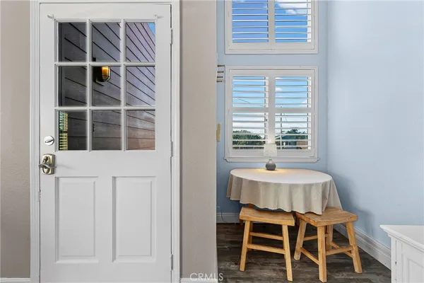 a kitchen with a table chairs a stove and a window