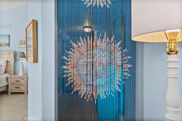 a bedroom with a bed and a mirror on dresser