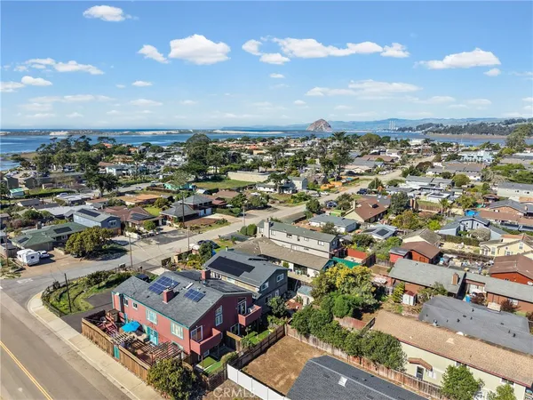an aerial view of a house with a mountain