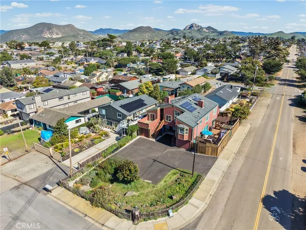 a view of a house with a yard and sitting area