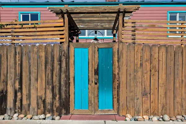 a view of a patio with couches table and chairs and wooden floor