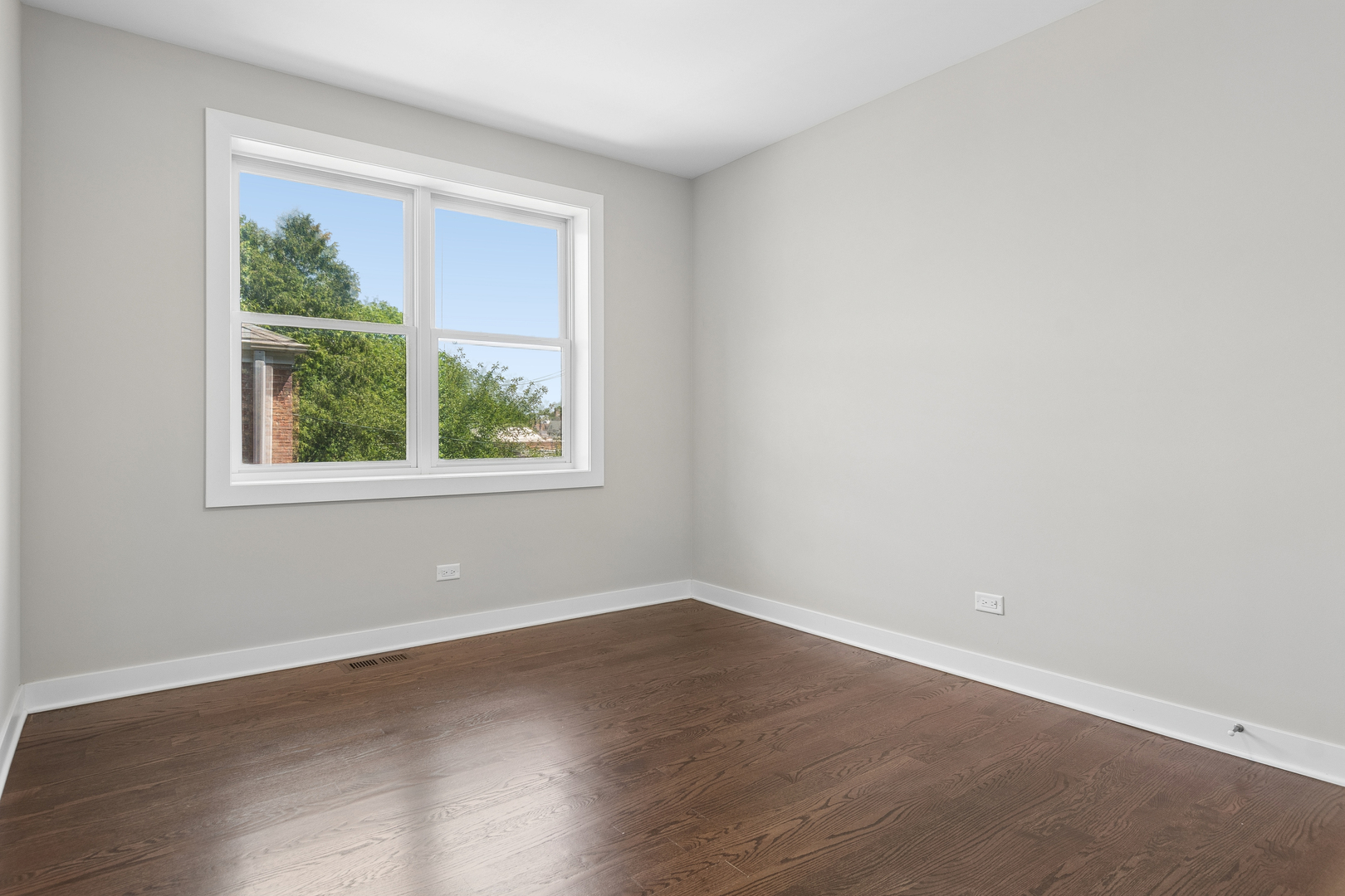 4845 North Keystone Avenue, Unit 2N Chicago, IL 60630 - Photo 17 of 21 an empty room with wooden floor and windows