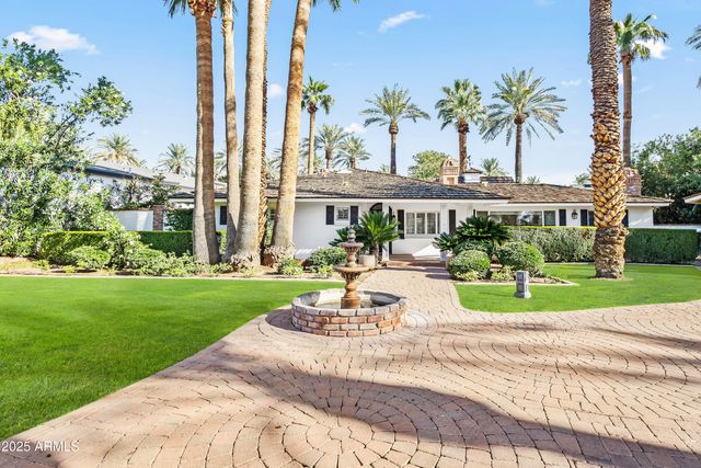a view of a house with a yard and sitting area