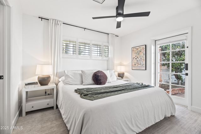 a bedroom with a large bed and a window