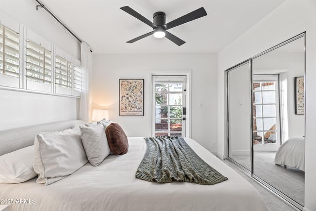 a bedroom with a bed and a large window