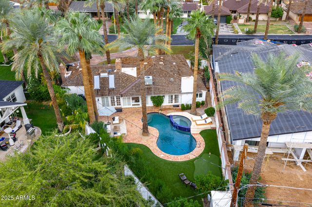 an aerial view of residential houses with outdoor space and parking