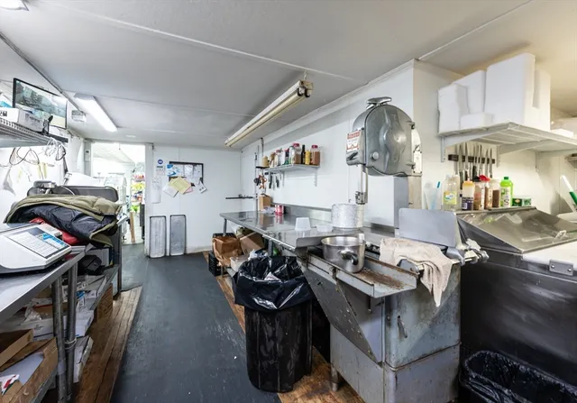 a living room with furniture and a piano