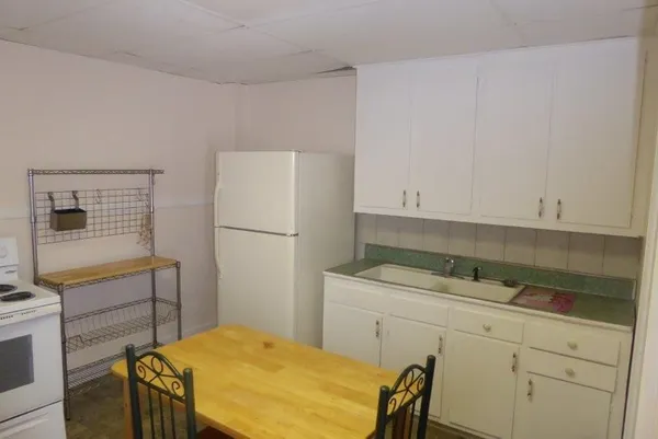 a bathroom with a sink a toilet and shower curtain