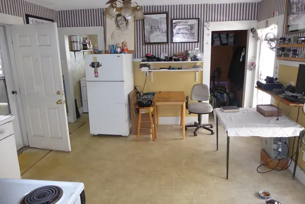 a kitchen with a refrigerator and a stove