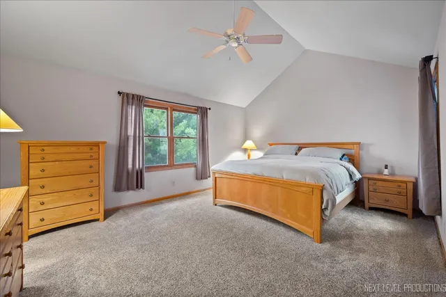 a spacious bedroom with a bed and a window