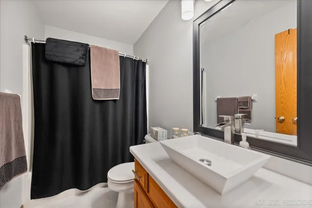 a bathroom with a sink a toilet and mirror