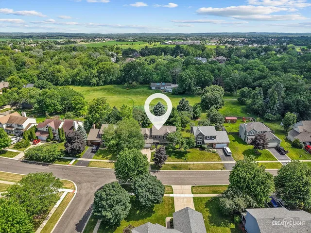 an aerial view of a house with a garden and a swimming pool