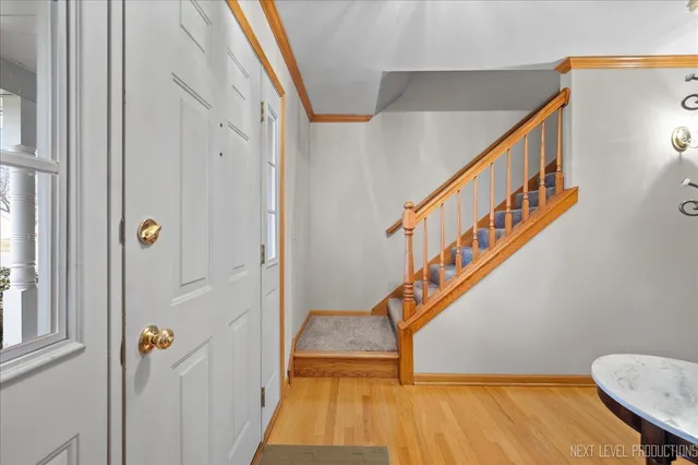 a view of entryway with wooden floor and stairs