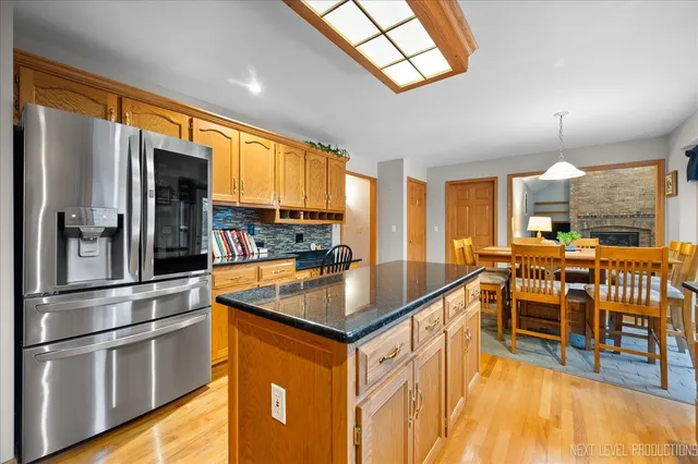 a kitchen with stainless steel appliances granite countertop a sink a stove and a refrigerator