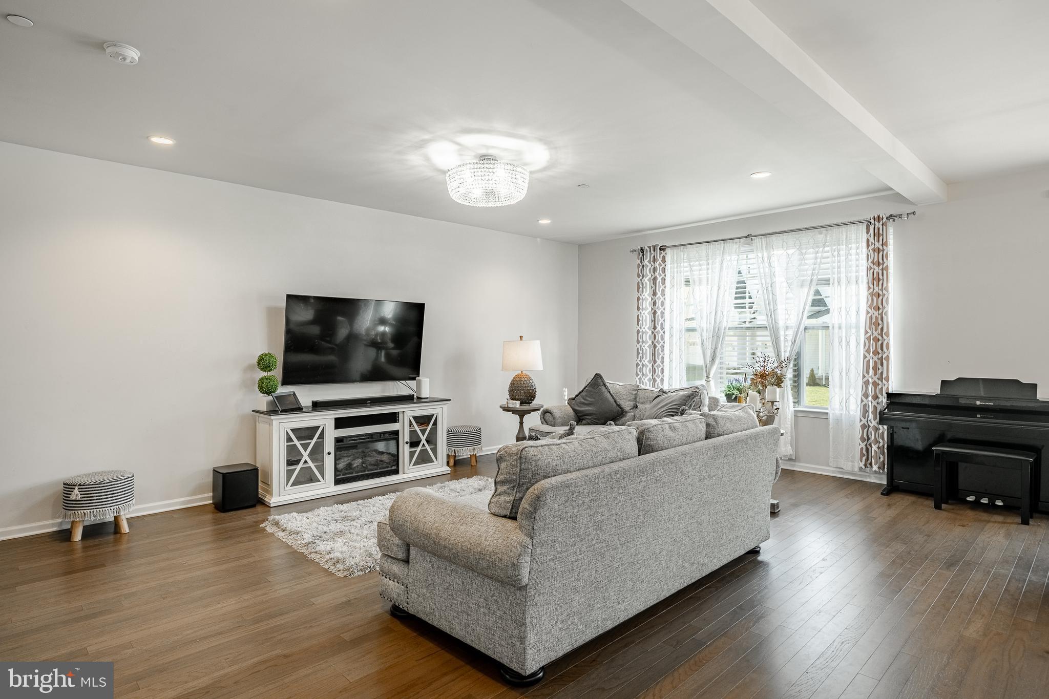 25 North Tompkins Square Downingtown, PA 19335 - Photo 12 of 53 a living room with furniture and a flat screen tv