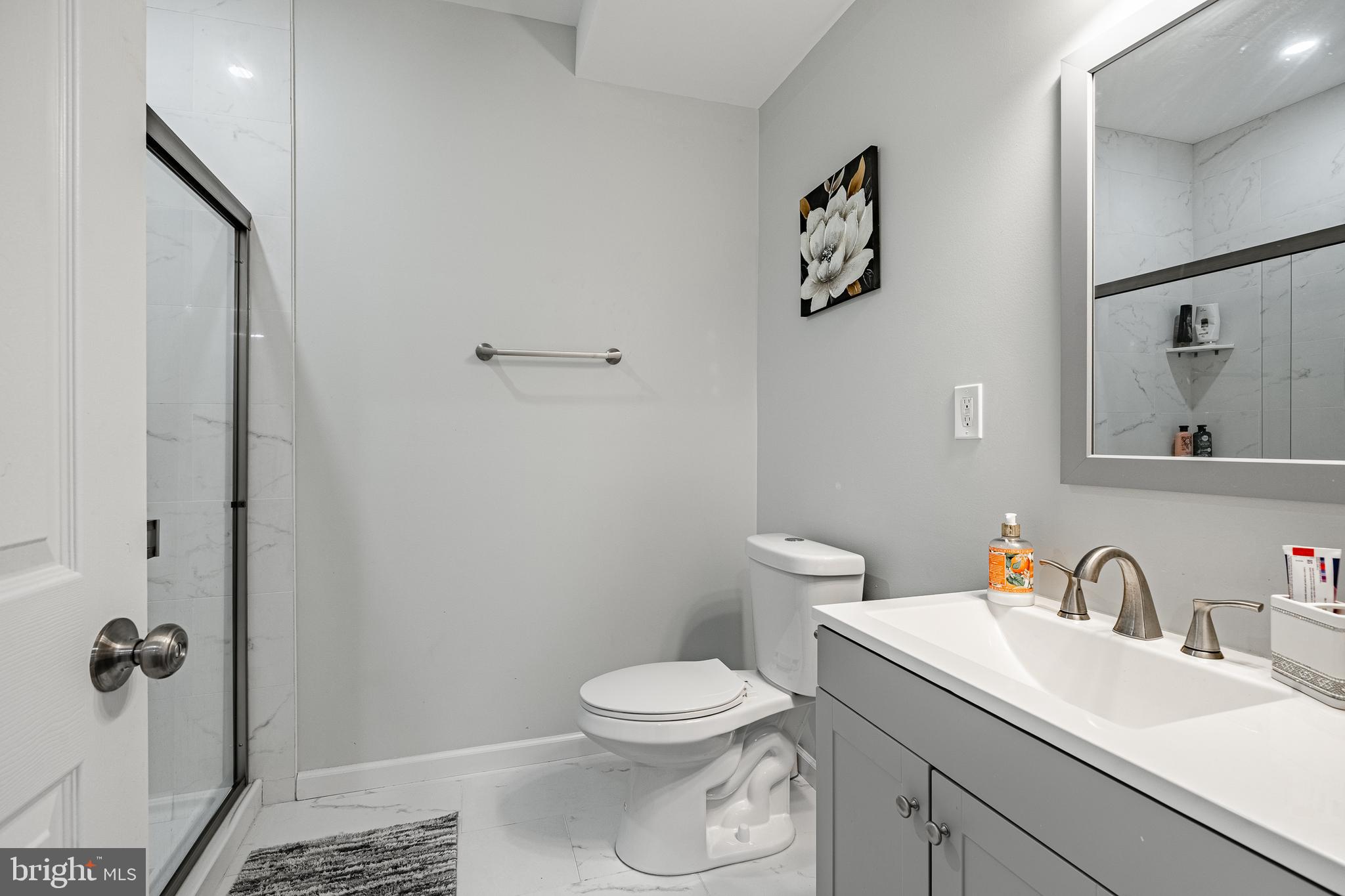 25 North Tompkins Square Downingtown, PA 19335 - Photo 38 of 53 a bathroom with a toilet a sink and mirror