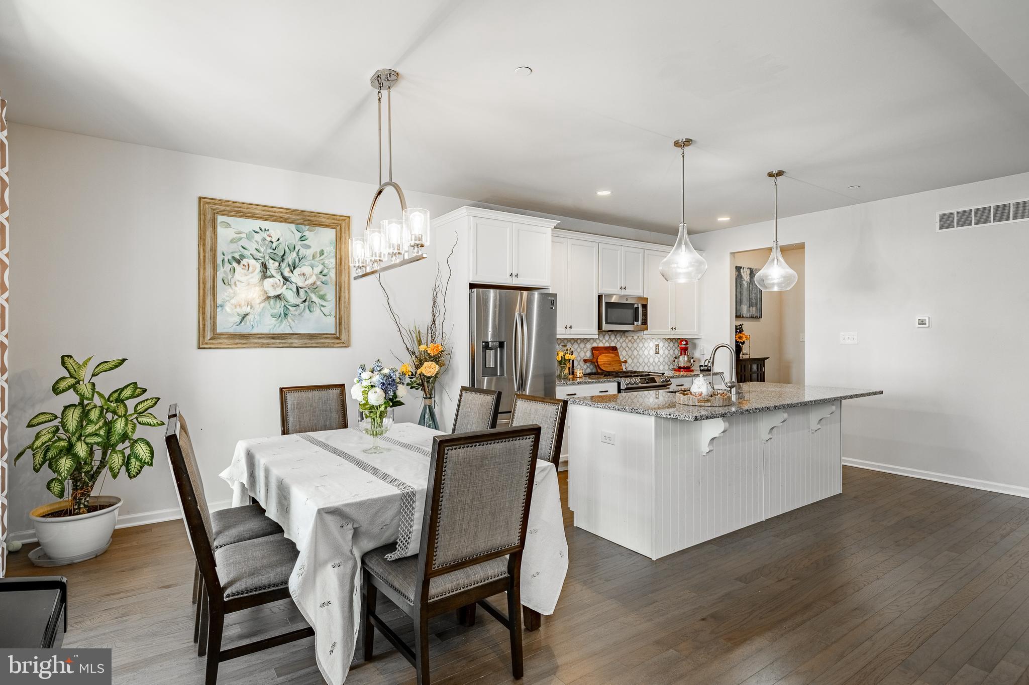 25 North Tompkins Square Downingtown, PA 19335 - Photo 9 of 53 a kitchen with kitchen island a table and chairs in it